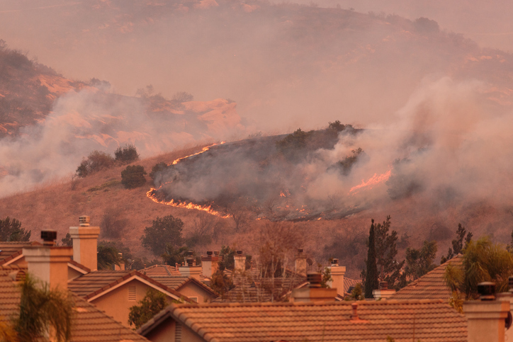 A view of the spreading flames from the Canyon Fire 2 wildfire in Anaheim Hills and the City of Orange