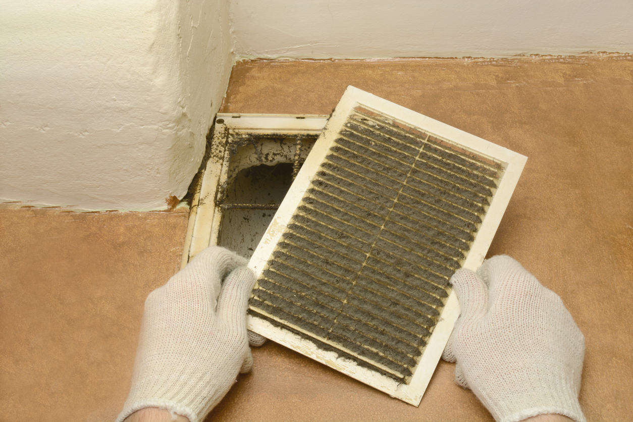 man removes dust ventilation grilles